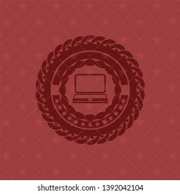 laptop icon inside retro red emblem