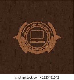 laptop icon inside retro wood emblem
