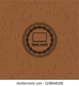 laptop icon inside retro wood emblem