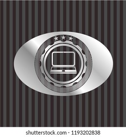 laptop icon inside silver emblem or badge