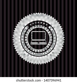 laptop icon inside silver emblem or badge