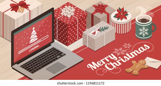 Laptop loading Christmas app, colorful gifts and decorations: Christmas card with wishes
