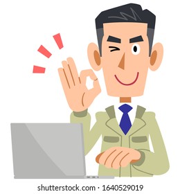 Laptop with man in construction shop giving OK sign