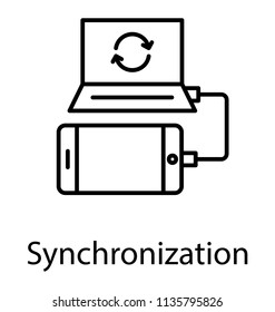 
Laptop and mobile phone connected with data cable for data synchronization 
