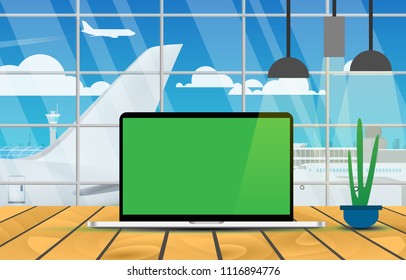 Laptop mockup with green screen for placing advertising screen, poster, wallpaper. Place on the wooden table for advertise in the cafe with airport and airplane with clear sky