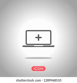 Laptop or notebook computer with medical cross on screen. Simple icon. Icon under spotlight. Gray background