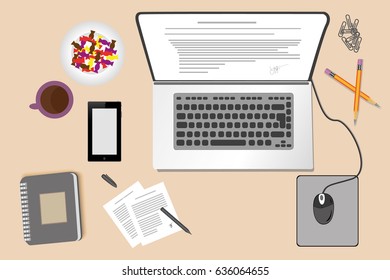 The laptop on the Desk next to notebook with documents. Is a Cup of coffee and a candy dish. Phone near the laptop.