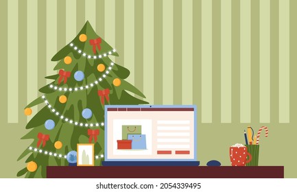 Portátil sobre la mesa sobre el fondo de un árbol de Navidad. Comprar en línea, comprar un regalo para Navidad. 