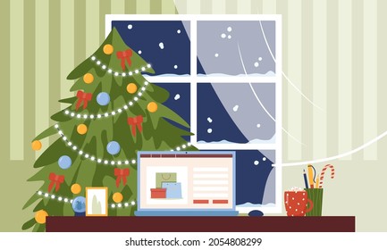 Portátil sobre la mesa sobre el fondo de un árbol de Navidad. Comprar en línea, comprar un regalo para Navidad. 