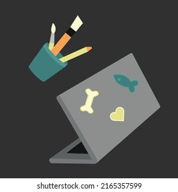 Laptop pencil stand. Open notebook, stickers, pencil, brushes.