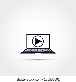 Laptop with play button icon
