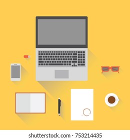 Laptop, smartphone, notepad, glasses and a cup of coffee on desktop. View from above.
