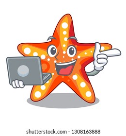 With laptop starfish beside the in character beach