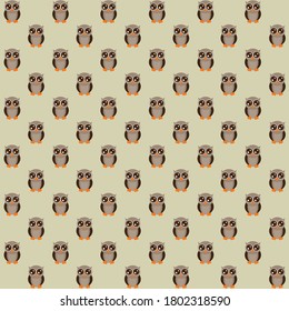 Large black eyes grey brown owl with orange beak and legs with grey background