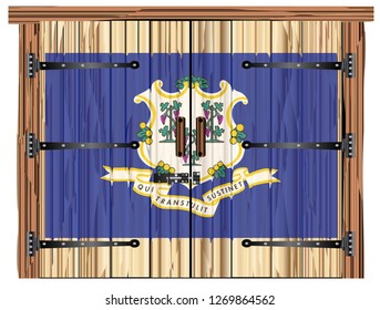 A large closed wooden barn double door with bolt and hinges and the Connecticut flag painted on