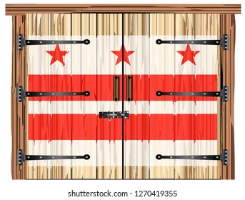 A large closed wooden barn double door with bolt and hinges and the Washington DC flag painted on