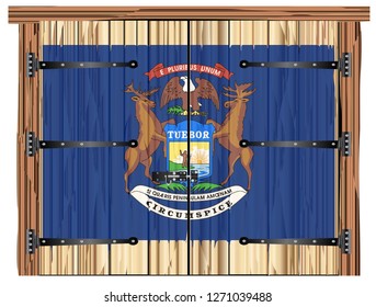 A large closed wooden barn double door with bolt and hinges and the Michigan state flag painted on