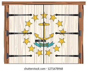A large closed wooden barn double door with bolt and hinges and the Rhode Island state flag painted on