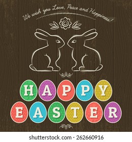 Large inscription Happy Easter written in eleven colored eggs. Wood background and two hand painted  bunnies.  Card for Easter.
Decorative element in Eastern style.
