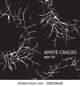 large numbers of white cracks in different directions on a black background