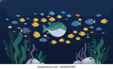 Large pufferfish swimming in dark ocean water surrounded by a school of diverse smaller fish among aquatic plants and rocks.
