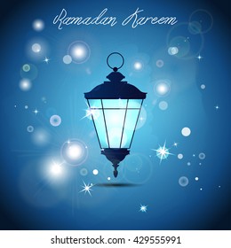 Large shiny lightened garden lantern with flashes and stars at night on blue background. For greeting cards, muslim holiday - Ramadan Kareem, Eid Mubarak, Eid-al-Adha