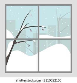 A large window with the snowy winter, a viburnum tree with snow on the branches and silhouettes of buildings in the background