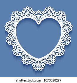 Laser cut paper lace frame in the shape of heart, vector illustration. Ornamental cutout photo frame with pattern. Abstract vintage background. Element for wedding invitation and greeting card.