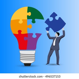 Last part of the solution business concept. Confident businessman in business suit with piece of puzzle in his hand going to finish with this piece light bulb puzzle. Concept of solution, idea born.