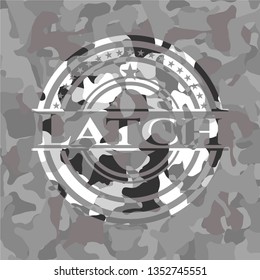 Latch written on a grey camouflage texture