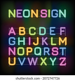 Latin alphabet made of glowing neon letters on a black background. Fluorescent letter with white bulbs in two rows. Multicolor led lamps for advertising or signage.