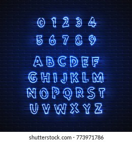 Latin neon font. Glowing alphabet, electric stand, against a brick wall background, calligraphic Abc..