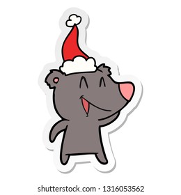 laughing bear hand drawn sticker cartoon of a wearing santa hat