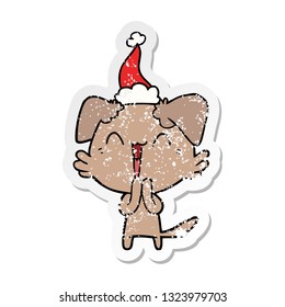 laughing little dog hand drawn distressed sticker cartoon of a wearing santa hat
