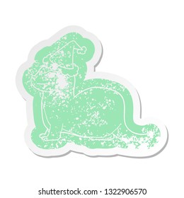 laughing otter quirky cartoon distressed sticker of a wearing santa hat