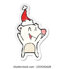 laughing polar bear hand drawn distressed sticker cartoon of a wearing santa hat