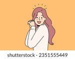 Laughing woman raises hands and looks at screen, enjoying meeting you or glad to receive good news. Laughing girl with long hair experiences delight and positive emotions after achieving goals