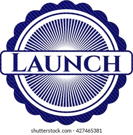 Insignia de lanzamiento con textura de denim