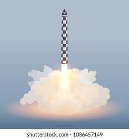 Launch of ballistic atomic missile. Russian rocket armed with a nuclear warhead starts in the clouds of smoke. Shell painted of black and white checkers like a German V-2 Retribution Weapon of WWII.