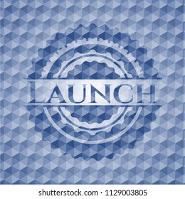 Launch blue emblem or badge with geometric pattern background.