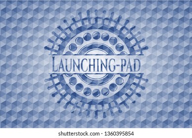 Launching-pad blue emblem with geometric pattern background.