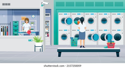 Laundromat Workers Are Ironing And Washing Clothes.