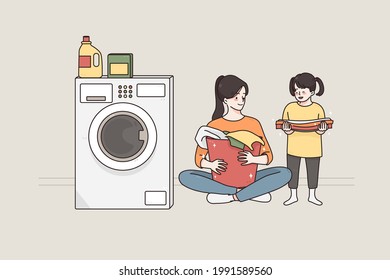 Laundry and spending time with children concept.Young smiling happy woman and her small daughter cartoon characters sitting on floor preparing dirty clothes for washing together vector illustration 