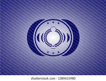 laurel wreath icon inside badge with denim texture