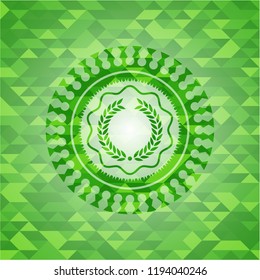 laurel wreath icon inside green emblem with mosaic ecological style background