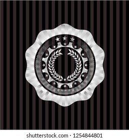 laurel wreath icon inside silvery badge