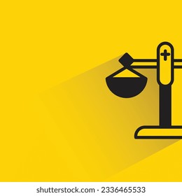 law balance scale with shadow on yellow background
