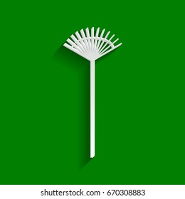 Lawn rake sign. Vector. Paper whitish icon with soft shadow on green background.