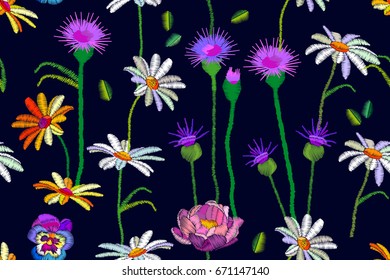 Lawn with thistles. Seamless vector pattern with embroidered texture. Wildflowers on dark blue background. Summer textile collection.