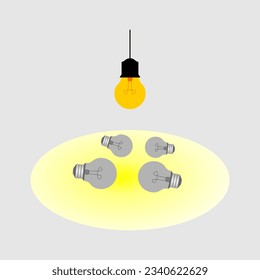 laying light bulbs with one hanging and illuminates another light bulb. concept of idea.